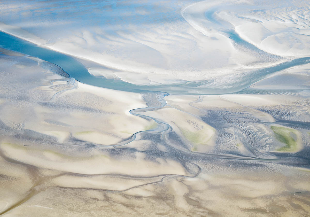 Abstrakte Luftaufnahme von Wasserläufen und Sandbänken im Wattenmeer
